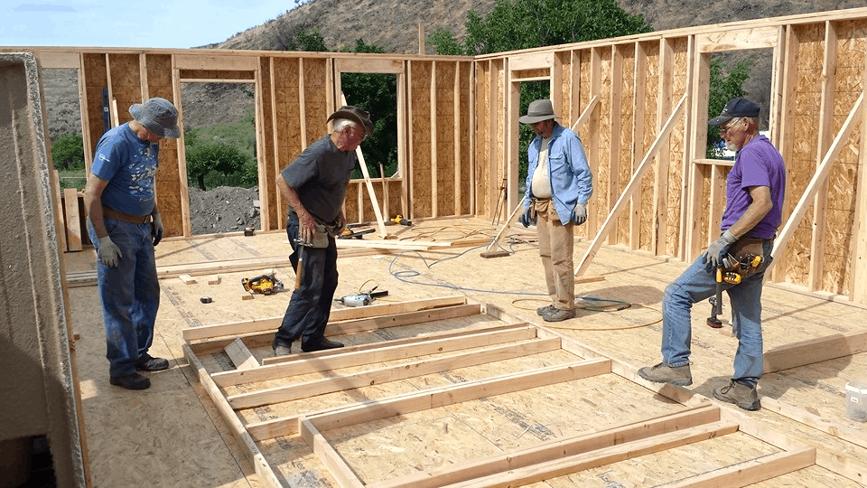 People constructing a home