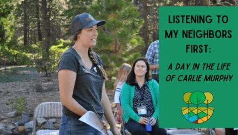 Carlie stands in front of a woman sitting with a clipboard